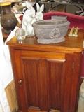 Walnut Victorian cabinet with stone bunnies and stone bowl