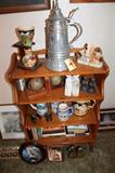 Bookshelf with books, steins / mugs, and bookends