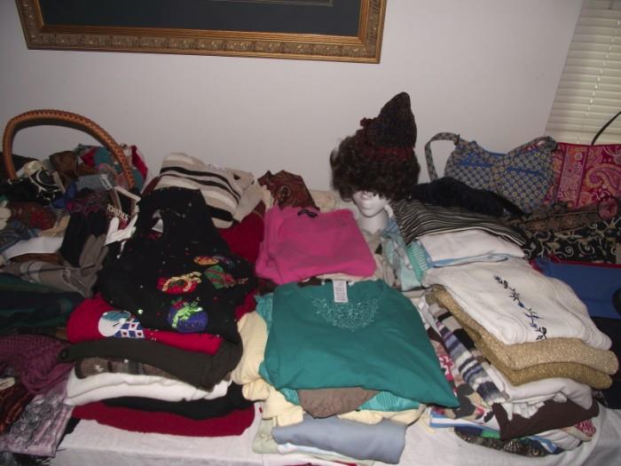 Tables full of large & extra large size women's clothes, plus a walk in closet