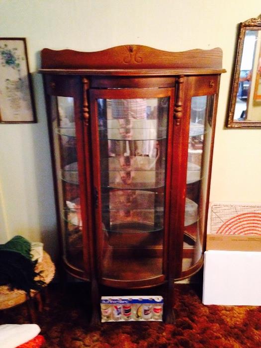 Older reproduction curved glass China cabinet. 