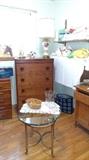 Round glass table with brass base. This has the shape of gold fish on its feet.