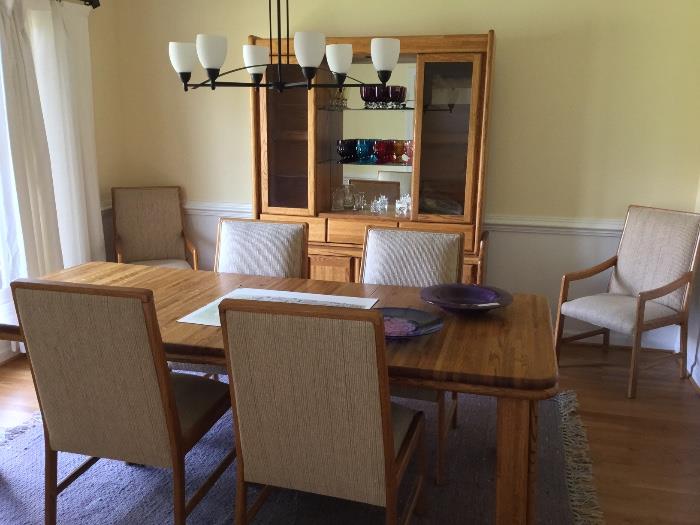 Oak dining room table with (2) leaves, 6 chairs and lighted China cabinet