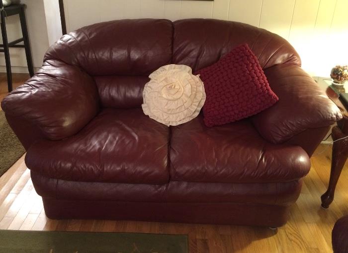 Great condition maroon-color leather loveseat - pillows are all for sale as well 
