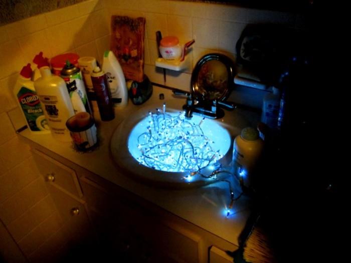 Unused home cleaning or bathroom products and a string of blue Christmas lights that work