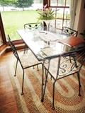 CLASSIC WROUGHT IRON TABLE WITH GLASS TOP.