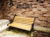 ONE OF 2 WOOD AND IRON OUTDOOR BENCHES
