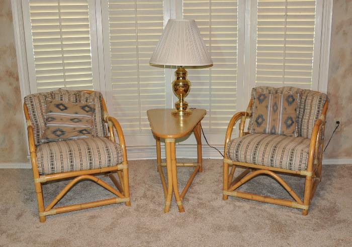 Pair of 1960s matching rattan chairs with new upholstery flank a wonderful triangle table..
