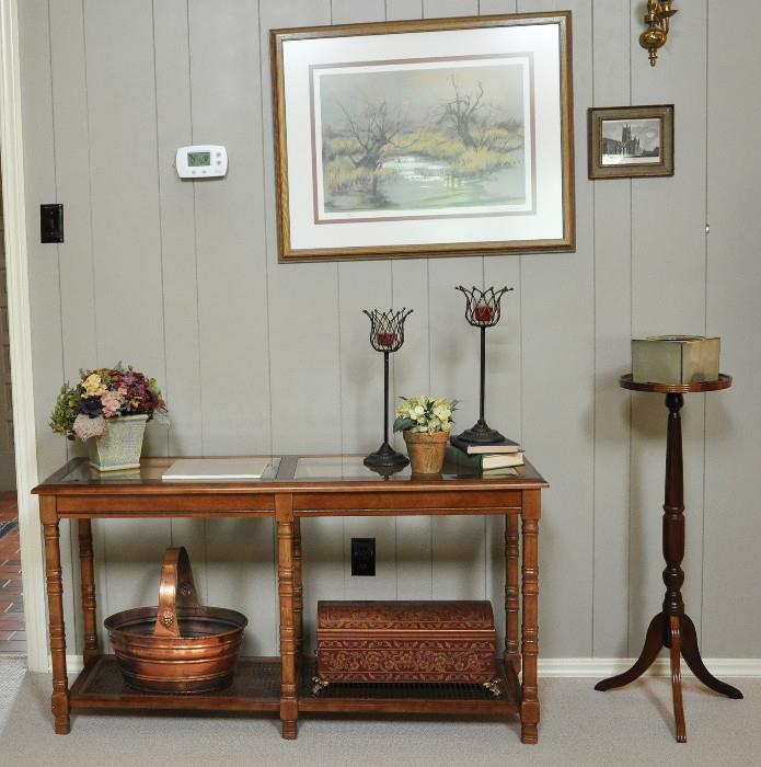 Console table with  several decorative pieces and a signed print.