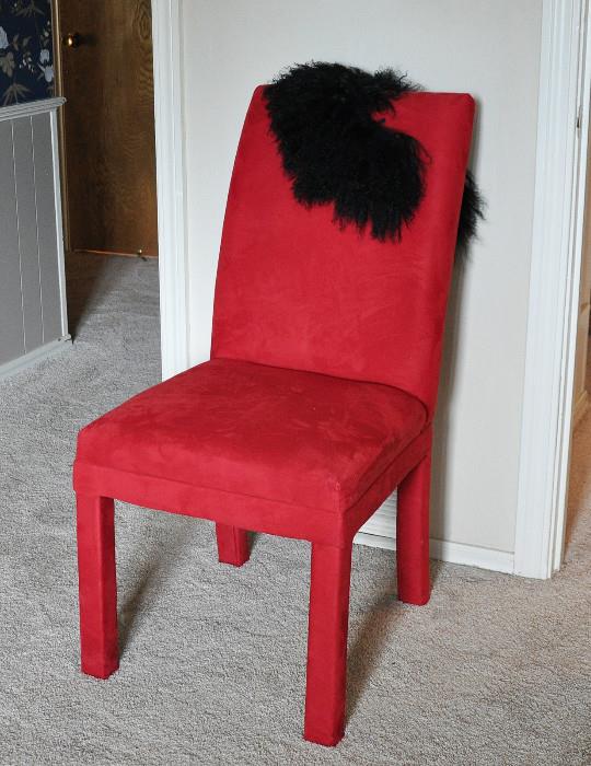 Classy red upholstered chair with a feather collar