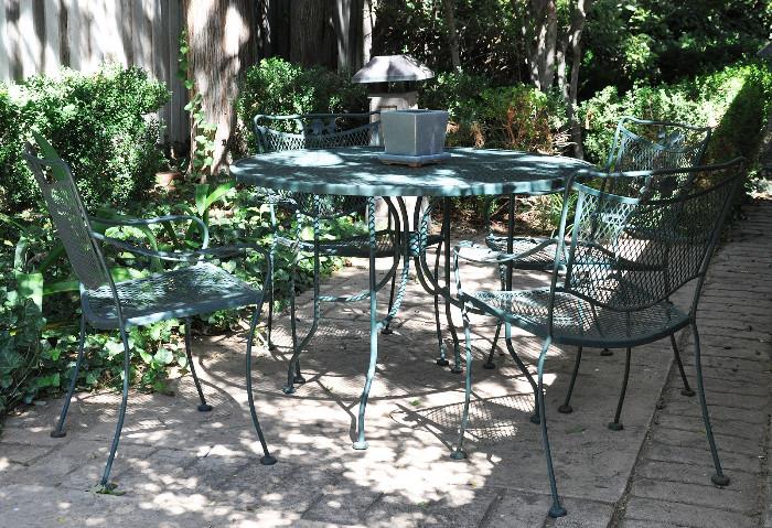 1 of 2 wrought iron tables with 4 chairs