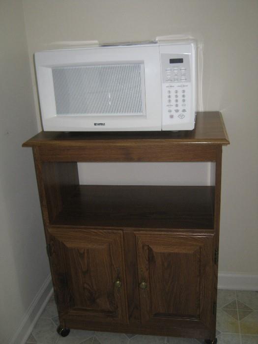 Kenmore microwave oven sitting on it's cart