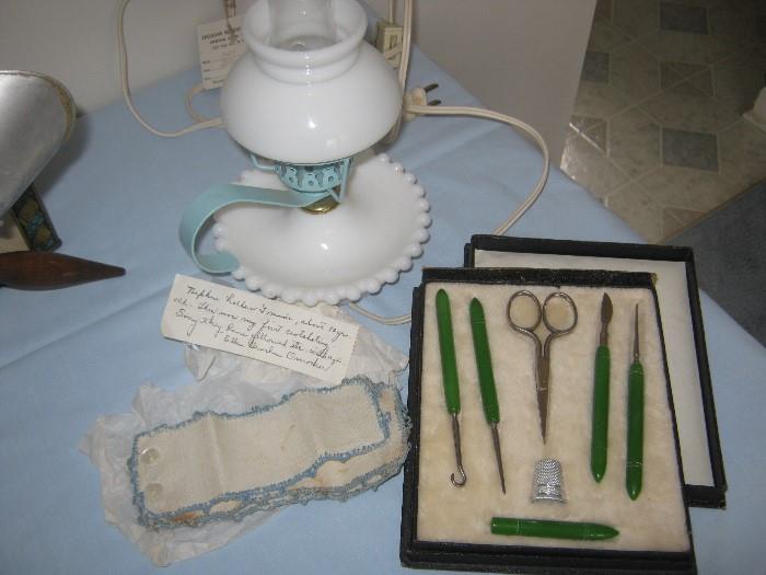 vintage milk glass bedside lamp, four antique hand-crocheted napkin rings, and an antique traveling sewing kit