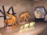 Carved elephant figurines. Wood and stone. Carved bone village scene in framed glass case