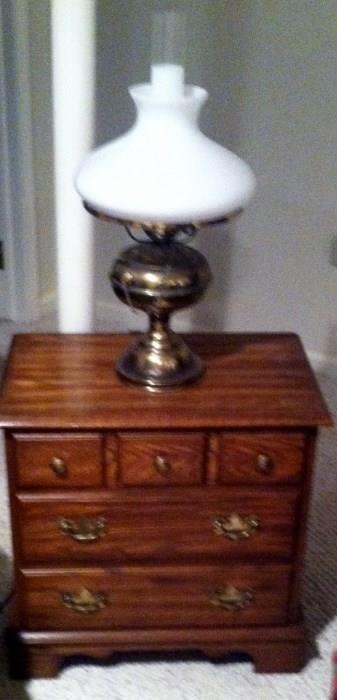 chest and brass hurricane lamp
