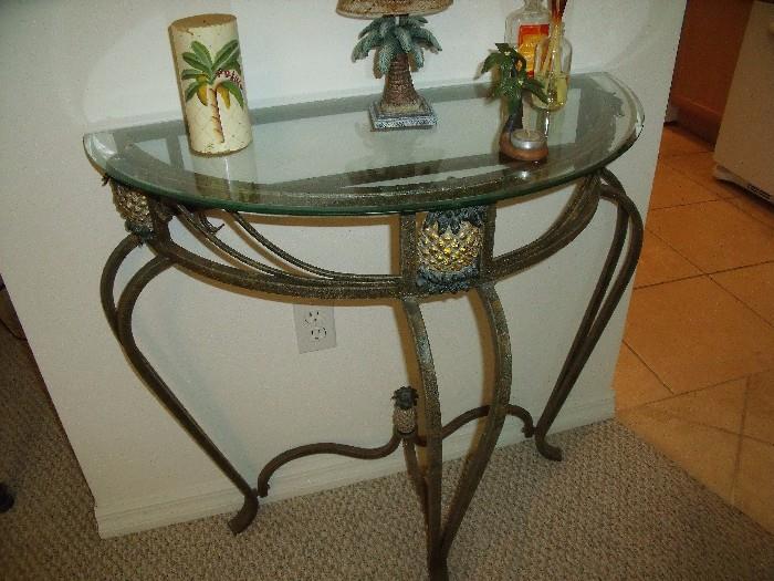 Close up of pineapple motif on table with palm tree items on top