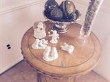 Beautiful corner wood table.  Snow babies figurines and snow globe and decorative accents all for sale. 