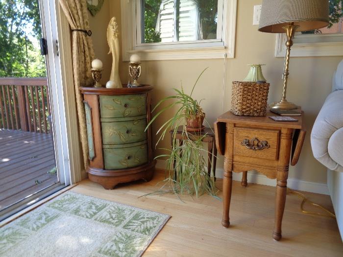 wooden end table, round dresser, plants lamp, area rug