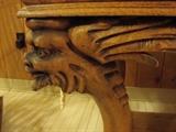 Carved head and wings on library table
