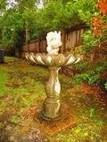 Concrete birdbath with squirrel