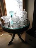 round glass top table with many crystal pieces