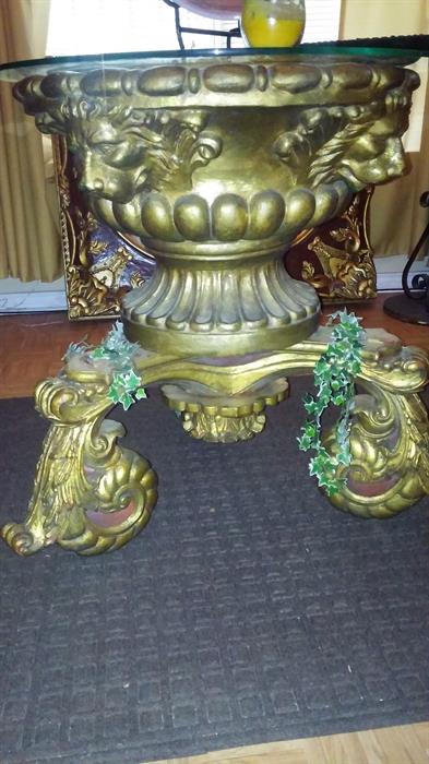 A beautiful center table that I have combined together, The bottom base is actually a hand carved coffee table upside down ,the top part is a large  Lion gilded pot with a glass top on top, This piece can be sold separate or together.

325.00