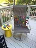 patio rocker chair, side table and outdoor artwork