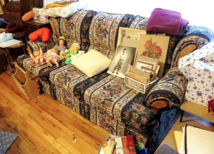 Sofa bed with vintage pictures and dolls