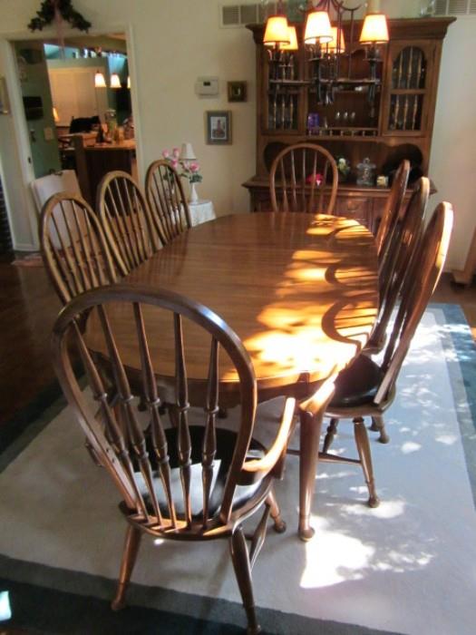 Thomasville oak dining room suite. Breakfront china cabinet, table with 3 leaves and eight chairs.