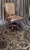 Carved Arm Swivel Desk Chair on Round Fringe Trimmed Area Rug