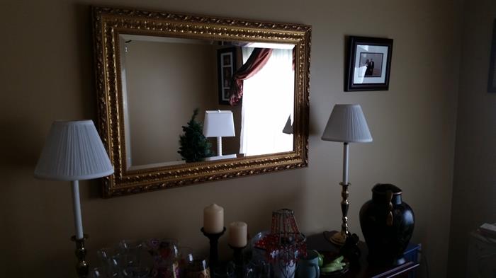 Ornate gold framed mirror and lamps