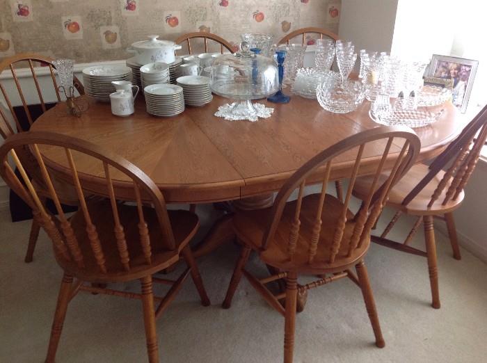 Solid wood dining table with six matching chairs and one extra leaf