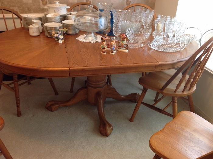 Solid oak dining table, six wooden chairs, one leaf