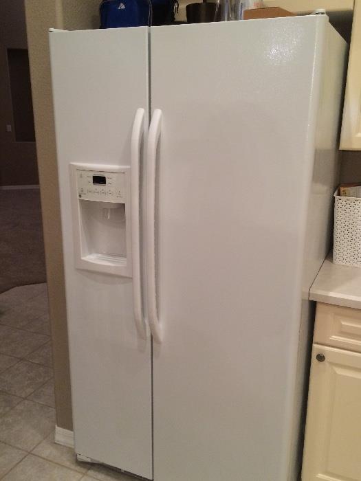 GE Profile side by side white refrigerator with water and ice dispenser