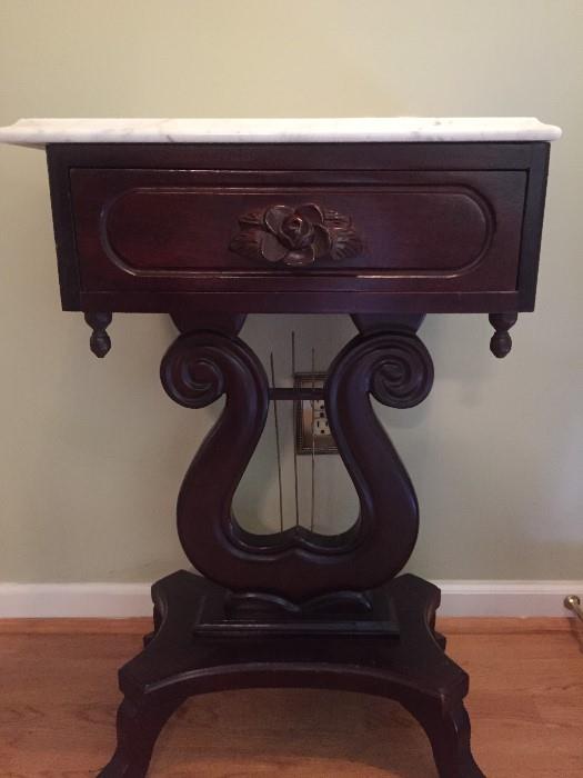 There are 3 of these amazing tables.  Antiques - marble tops, carved embellishment on drawer and harp bottoms