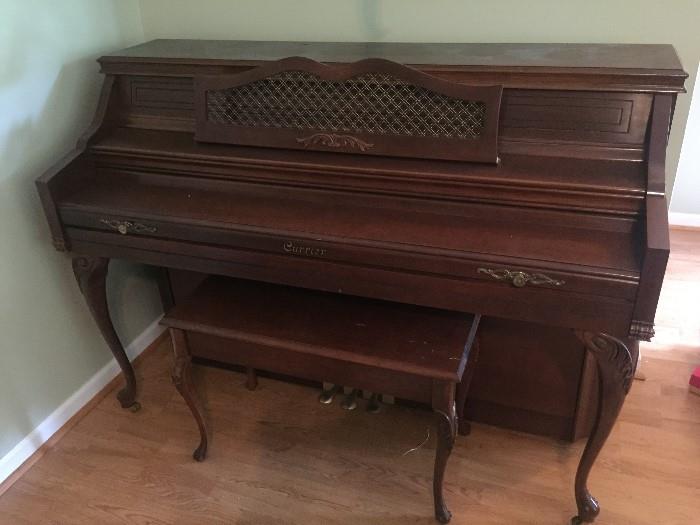 This immaculate piano and bench were manufactured by Currier.