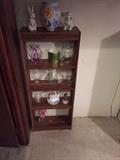 bookcase with vases and ceramic ware