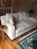 Transitional style love seat, green oriental rug and oak round side table