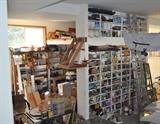 Just one small section of a 1,200 square foot garage! Several ladders, Craftsman 10" table saw, tile, paint, paint supplies, woodworking tools, automotive items, wrenches, Stanley planes, helmets, wood, apple press... the list keeps going and going!