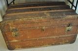 Wonderful and very old trunk with wood and leather handles on either side.