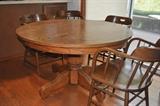 Round oak table, 6 oak captains chairs.