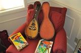 Antique mandolin in case, Superman pop-up book, assorted comic books.