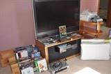 Various VHS and DVDs, VHS player, television stand, Toshiba HD LCD 36" flat screen television TV, Wii Fit Plus, Wii Sports.