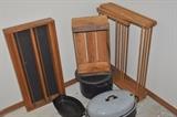 Wall cabinet, old wooden crate, wooden folding laundry rack, old canning pot, vintage enamel roasting pan.