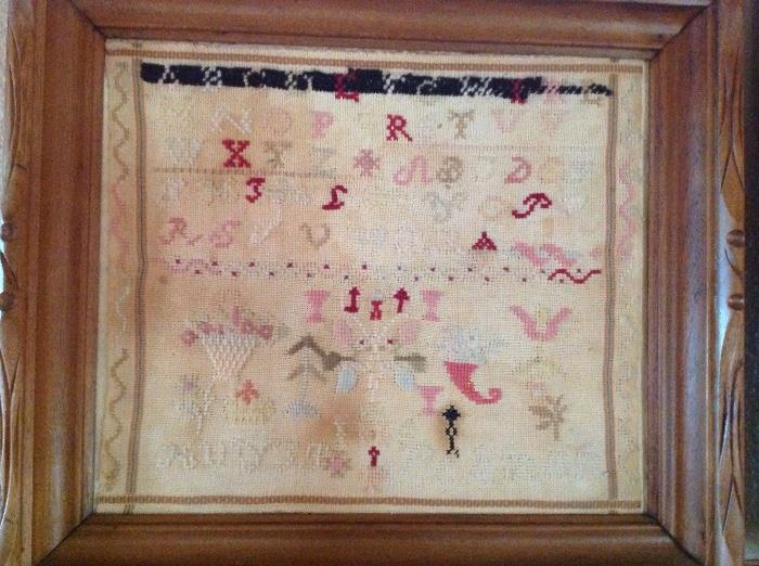 Vintage sampler shows some fading, but has nice stitch work 