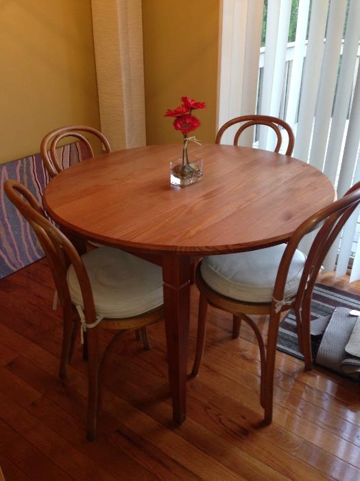 Real wood 42" dining room table with four chairs and pads