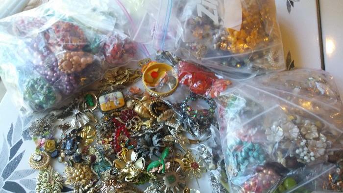 A whole rubbermaid container of costume jewelry - this is just some of it, yet to be ed but there are many earring and necklace sets, many 1950s and 60s pieces, flowers, fun, thermoset plastics