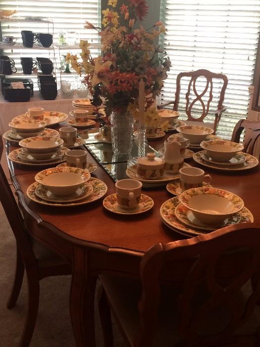 Lovely dining table (2 leaves) has matching china cabinet.