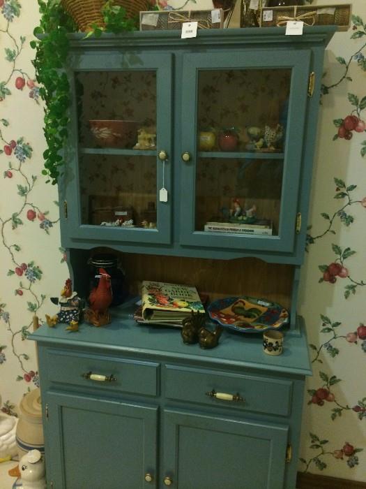 Blue hutch, cookbooks, decorative roosters & fruit