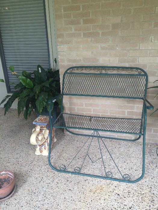 Green patio settee; small elephant plant stand