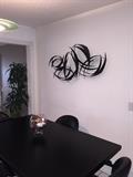 MODERN BLACK KITCHEN TABLE AND 4 ROLLING CHAIRS & METAL WALL ART